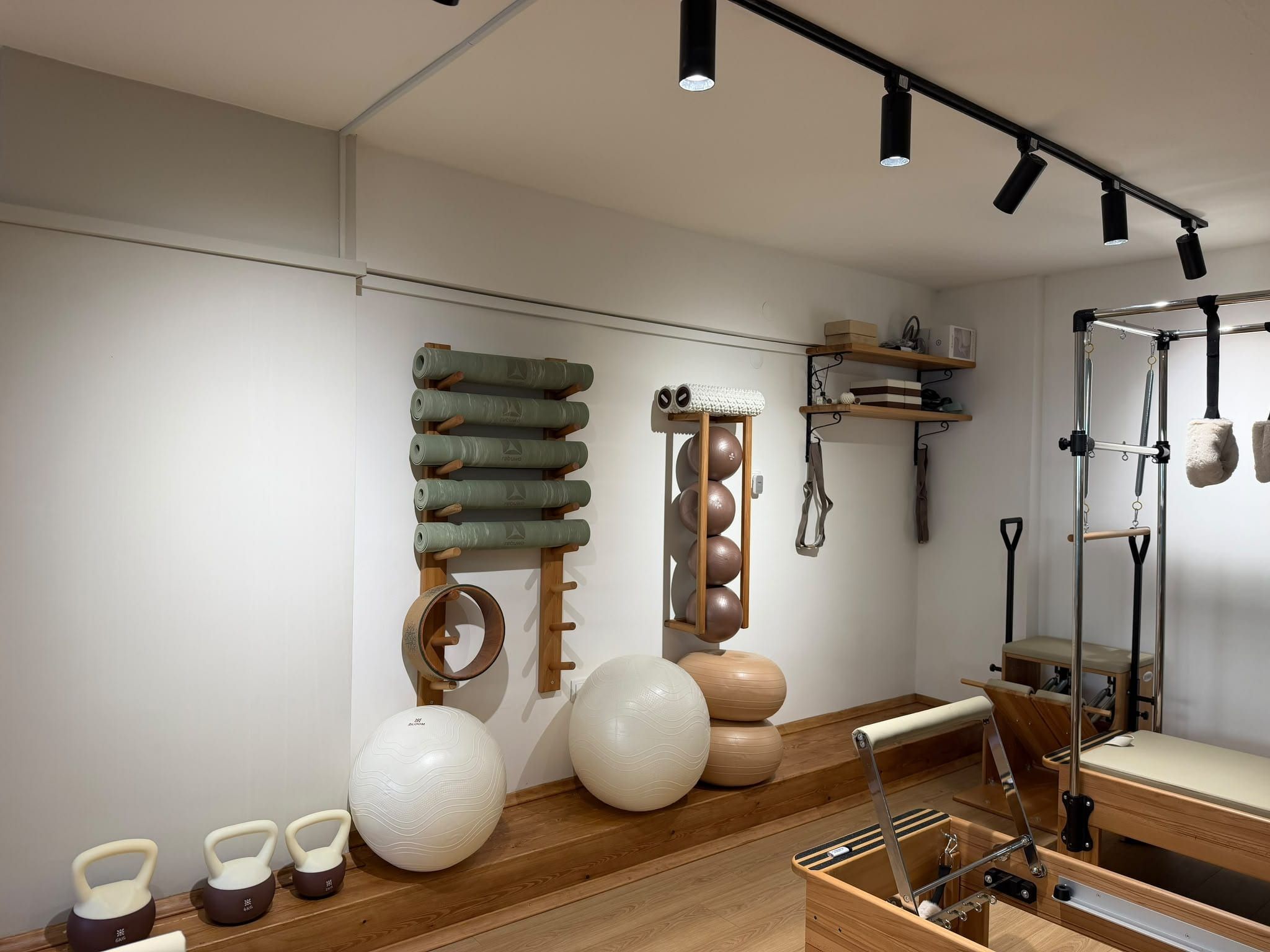 Studio wall with mats, balls and wooden racks